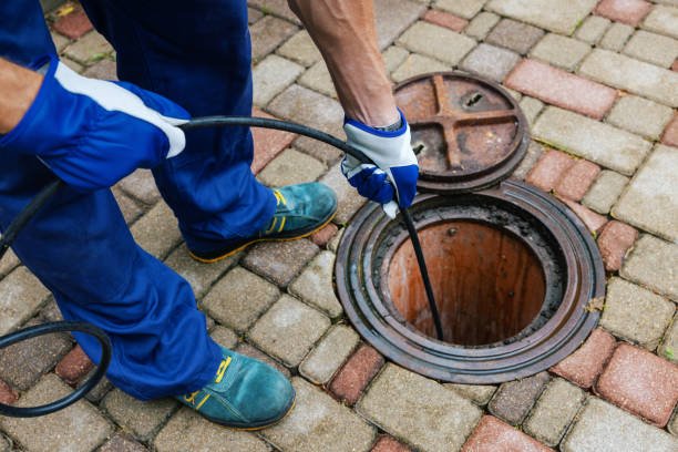 sewer cleaning service worker clean a clogged drainage with hydro jetting